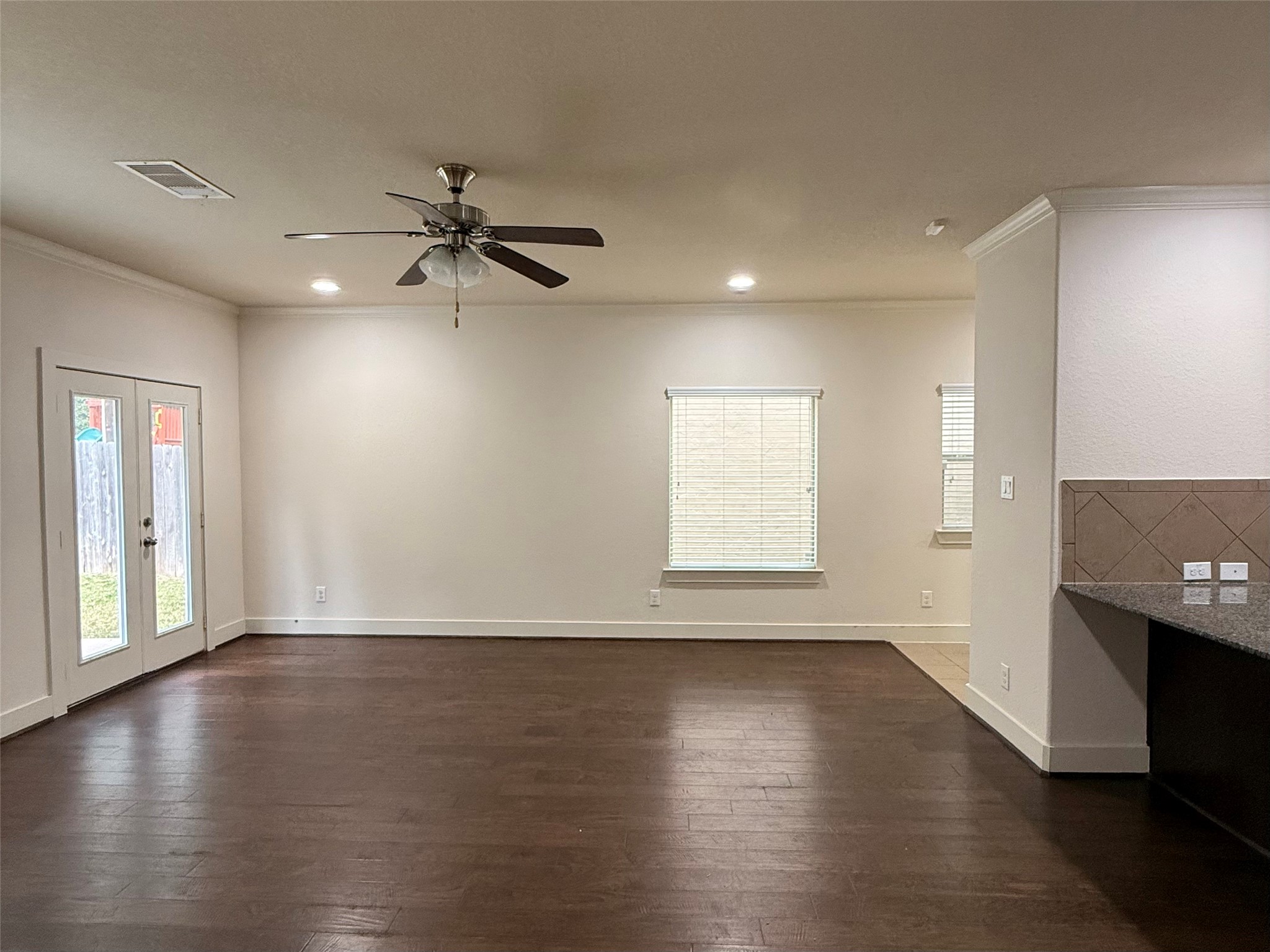 20607 Alfonso Court Spring, TX 77388 - Photo 7 of 25 Spacious living area with hardwood flooring, recessed lighting, and backyard access.