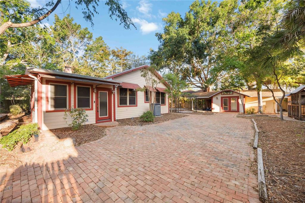 1721 8th Street Sarasota, FL 34236 - Photo 18 of 41 a front view of a house with a garden and trees