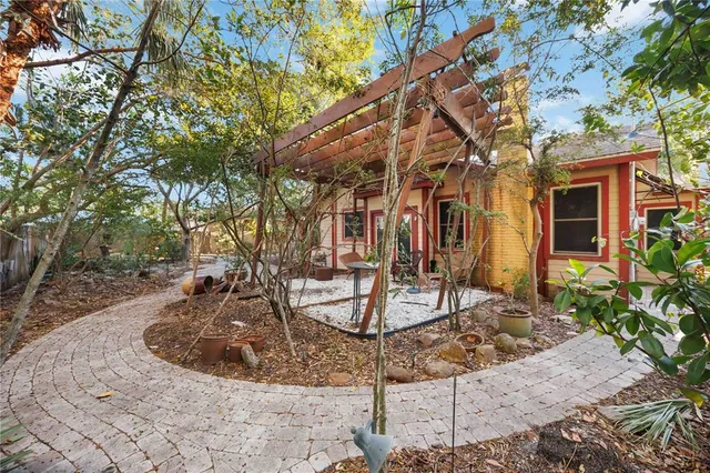 an aerial view of residential house with outdoor space and trees all around