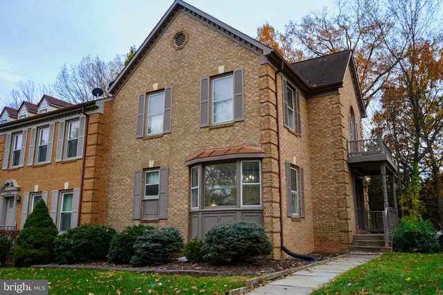 a front view of a house with plants and garden