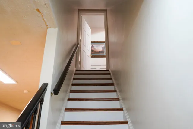 a view of an empty room with a fireplace and a window