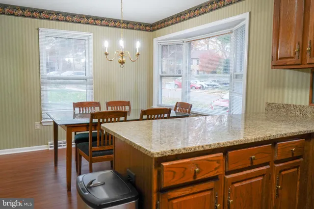 a kitchen with a sink cabinets and wooden floor