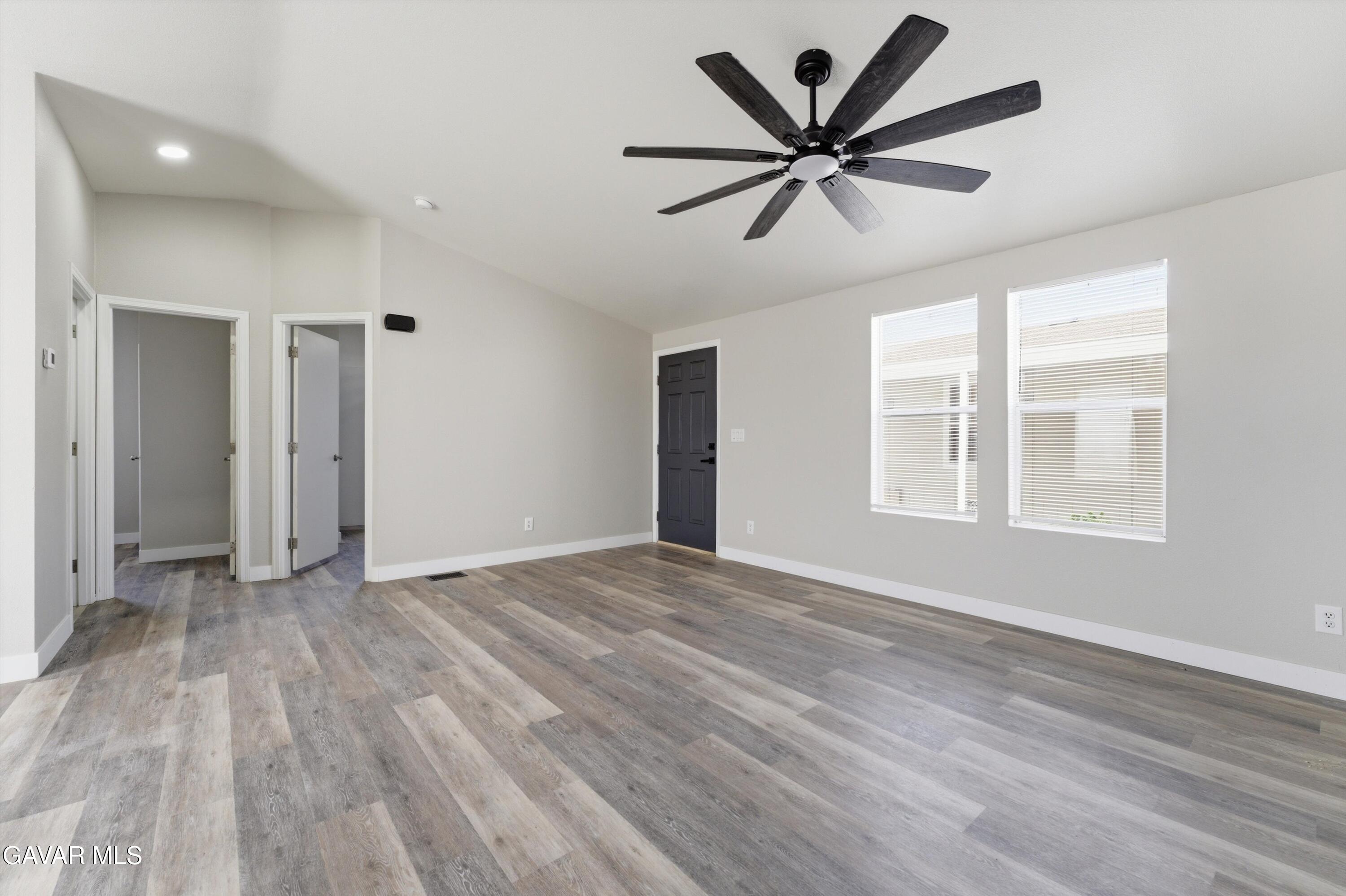 20843 Waalew Road Apple Valley, CA 92307 - Photo 21 of 40 a view of empty room with wooden floor and ceiling fan