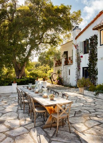 a view of a patio with table and chairs with wooden floor and fence