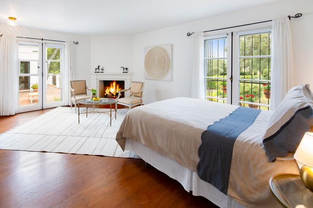 a bedroom with a bed chair and window