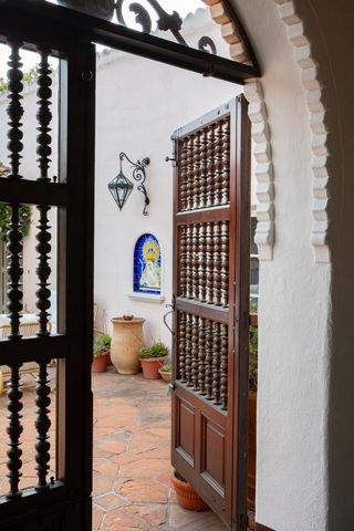 a patio with glass top table and chairs