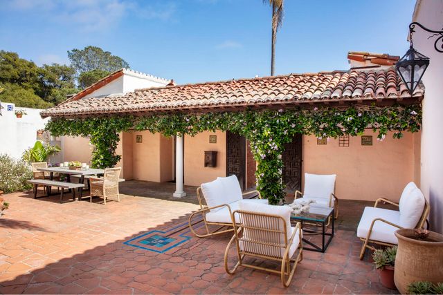 a view of a patio with table and chairs and potted plants