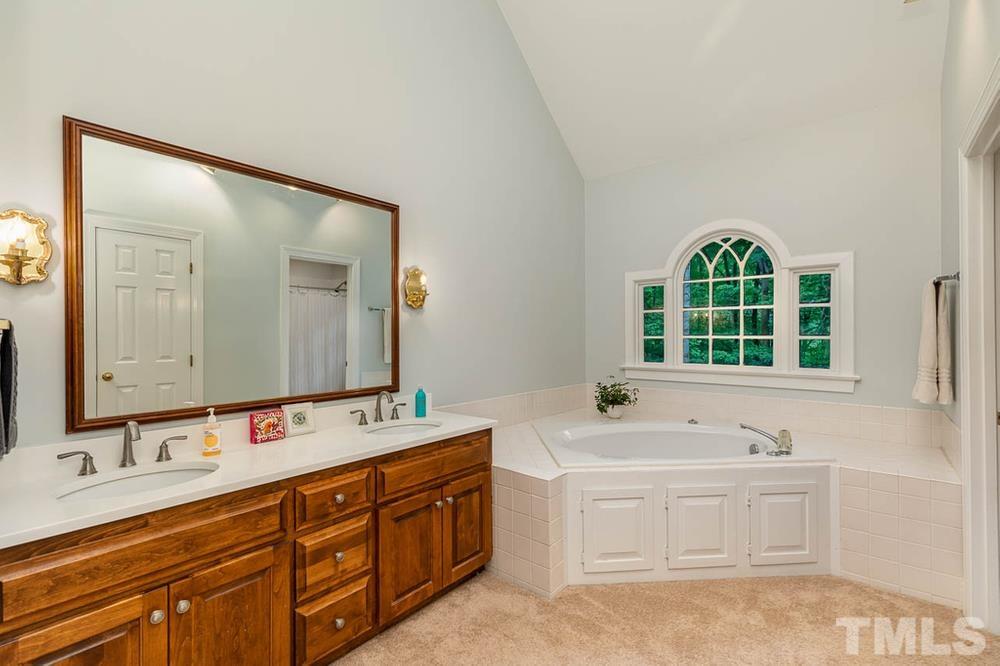 705 Presnell Court Raleigh, NC 27615 - Photo 11 of 30 a bathroom with a double vanity sink mirror and double