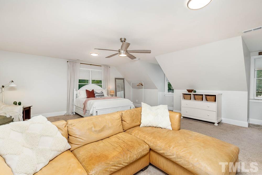 705 Presnell Court Raleigh, NC 27615 - Photo 13 of 30 a bed room with a bed and a chandelier