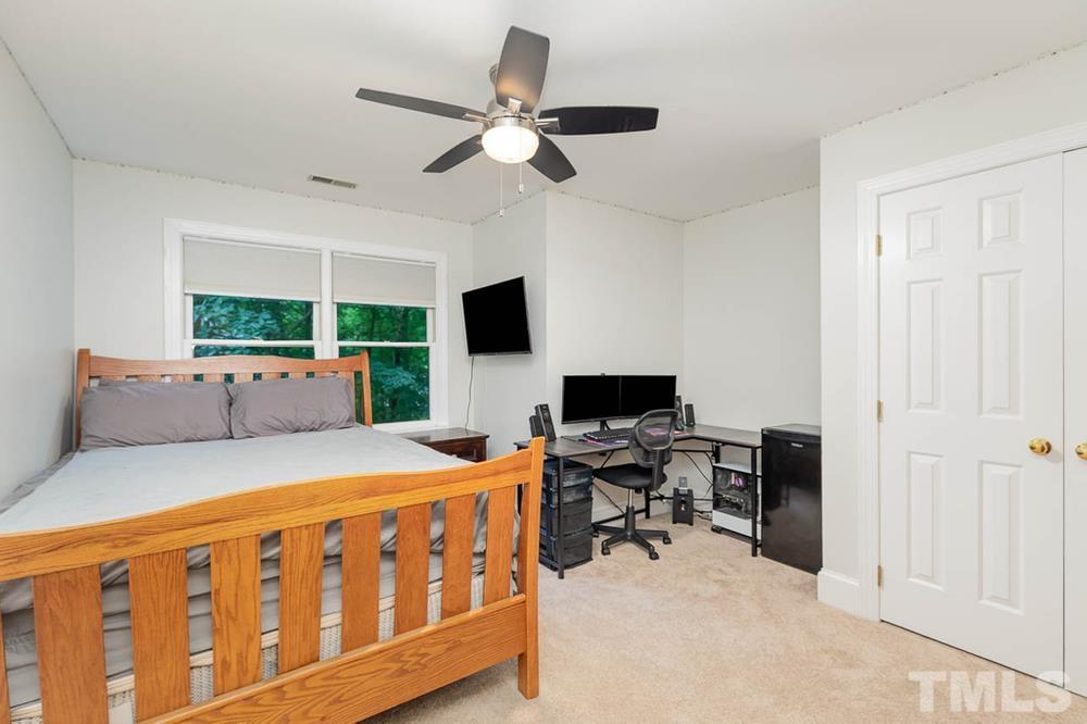 705 Presnell Court Raleigh, NC 27615 - Photo 14 of 30 a bedroom with furniture and a window