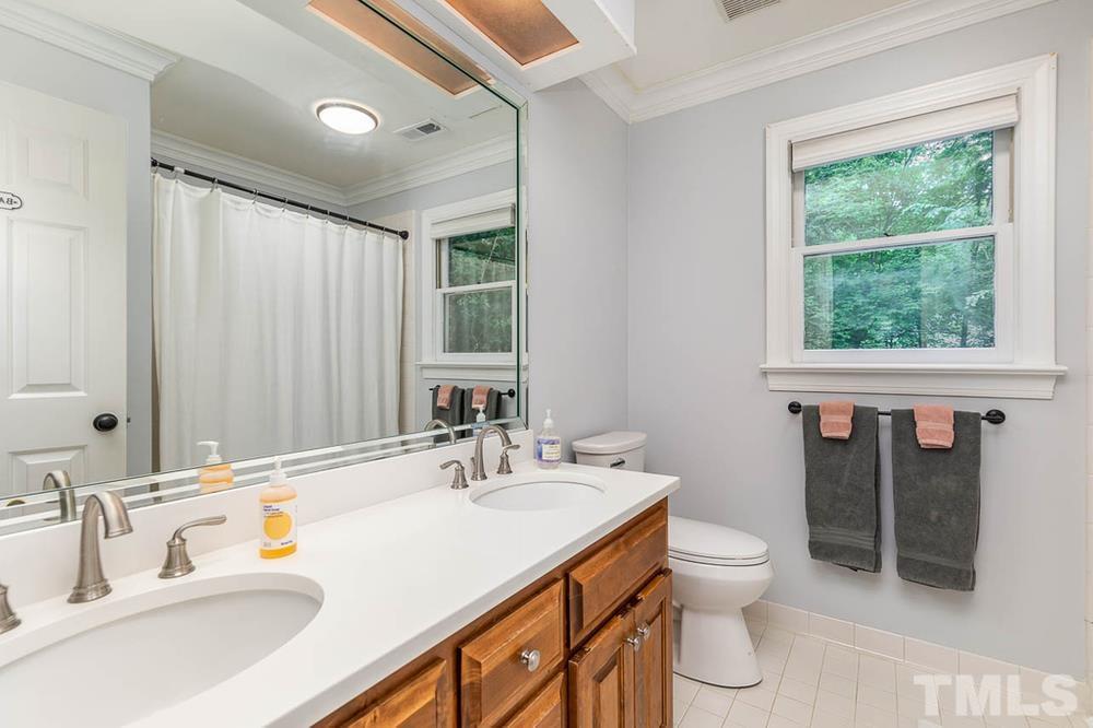 705 Presnell Court Raleigh, NC 27615 - Photo 15 of 30 a bathroom with a sink double vanity and a toilet