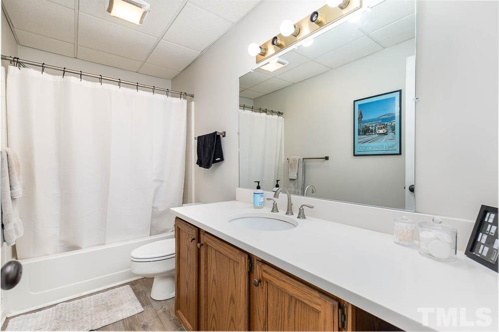 705 Presnell Court Raleigh, NC 27615 - Photo 19 of 30 a bathroom with a sink a toilet and shower