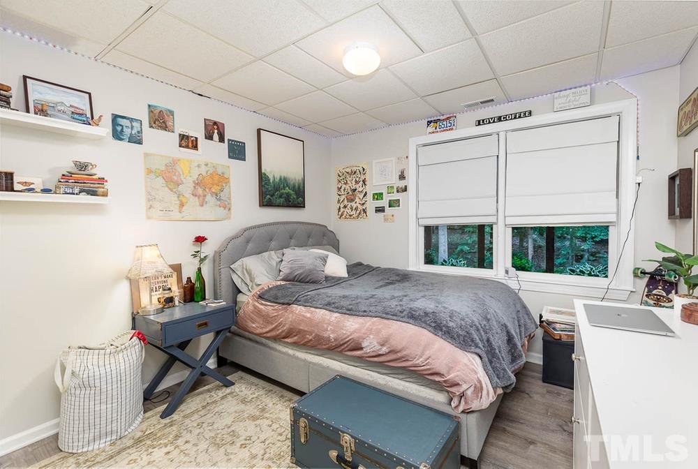 705 Presnell Court Raleigh, NC 27615 - Photo 20 of 30 a bed sitting in a bedroom next to a window