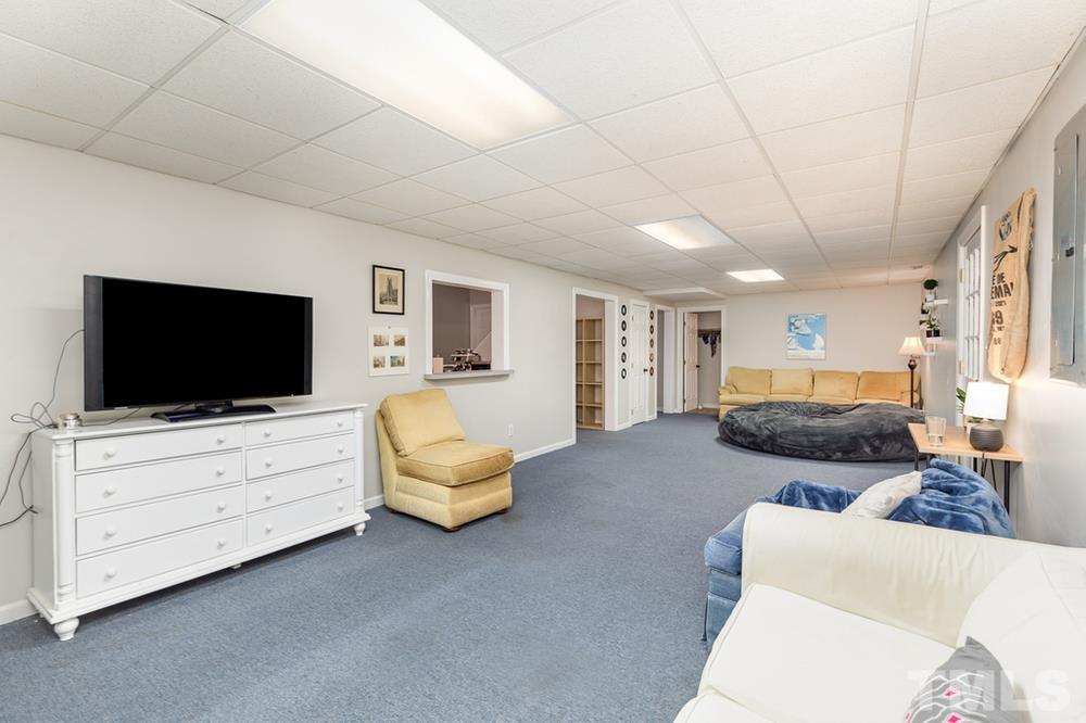 705 Presnell Court Raleigh, NC 27615 - Photo 22 of 30 a bedroom with furniture and a flat screen tv