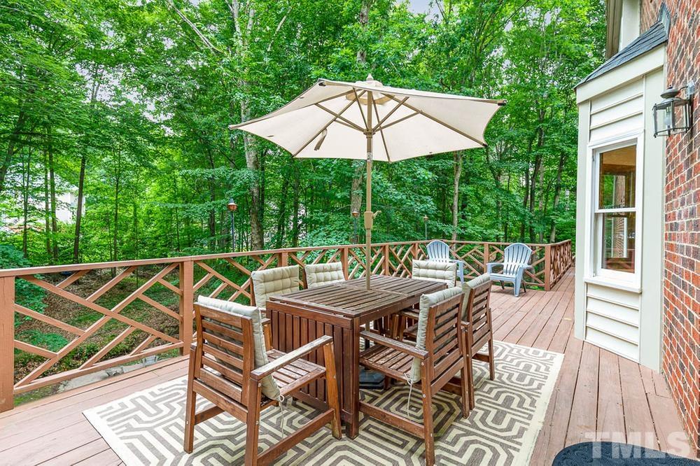 705 Presnell Court Raleigh, NC 27615 - Photo 23 of 30 a view of a patio with a table and chairs