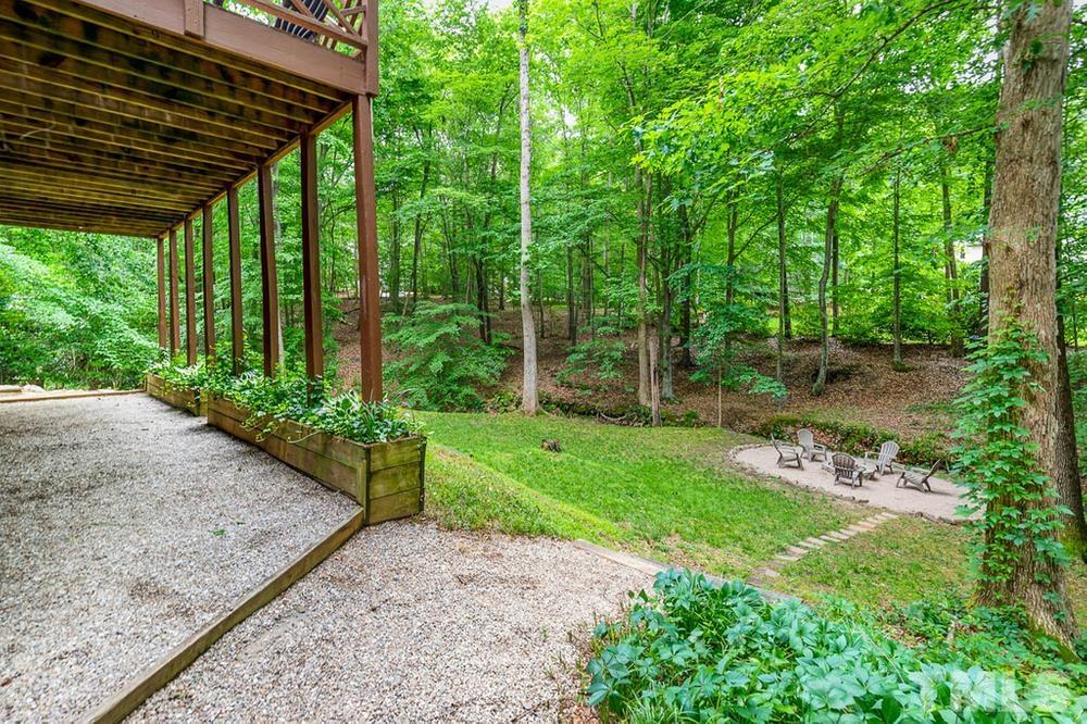705 Presnell Court Raleigh, NC 27615 - Photo 25 of 30 a view of a backyard with plants and large trees