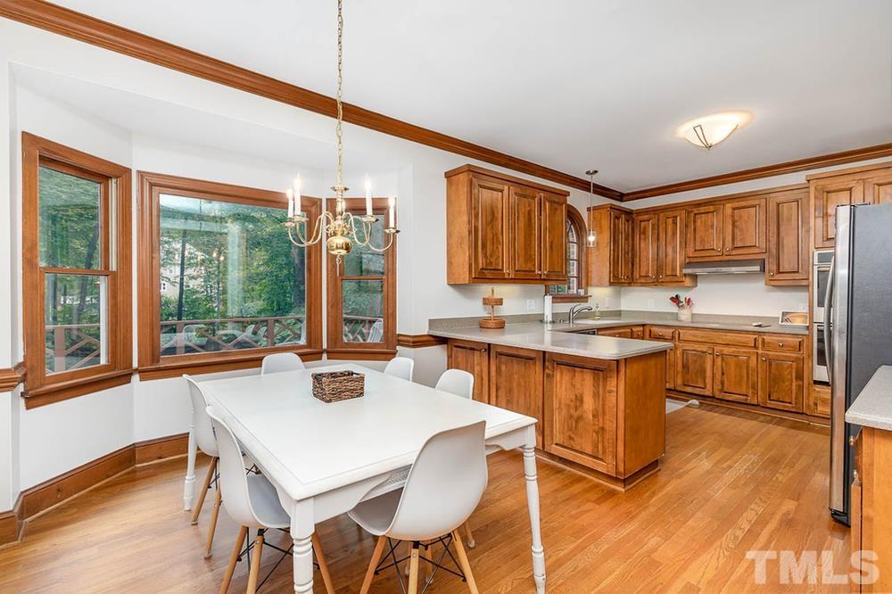 705 Presnell Court Raleigh, NC 27615 - Photo 4 of 30 a view of a dining room with furniture window and wooden floor