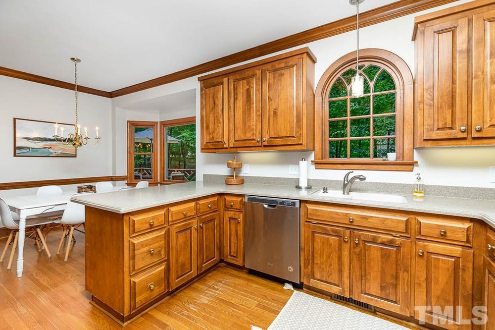 705 Presnell Court Raleigh, NC 27615 - Photo 5 of 30 a kitchen with stainless steel appliances granite countertop a stove and a sink