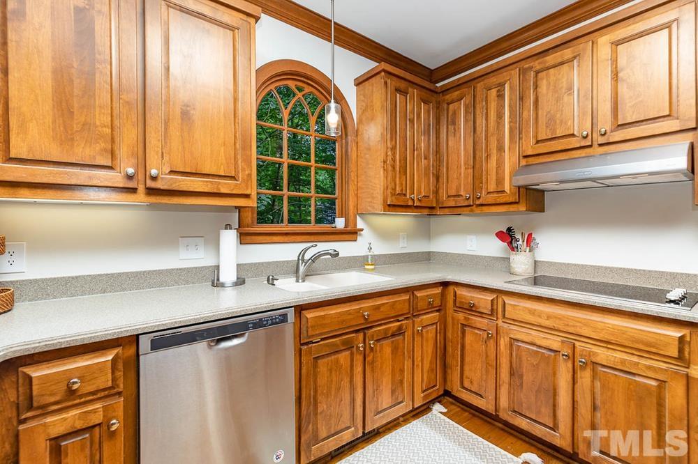 705 Presnell Court Raleigh, NC 27615 - Photo 6 of 30 a kitchen with stainless steel appliances granite countertop a sink a stove and cabinets