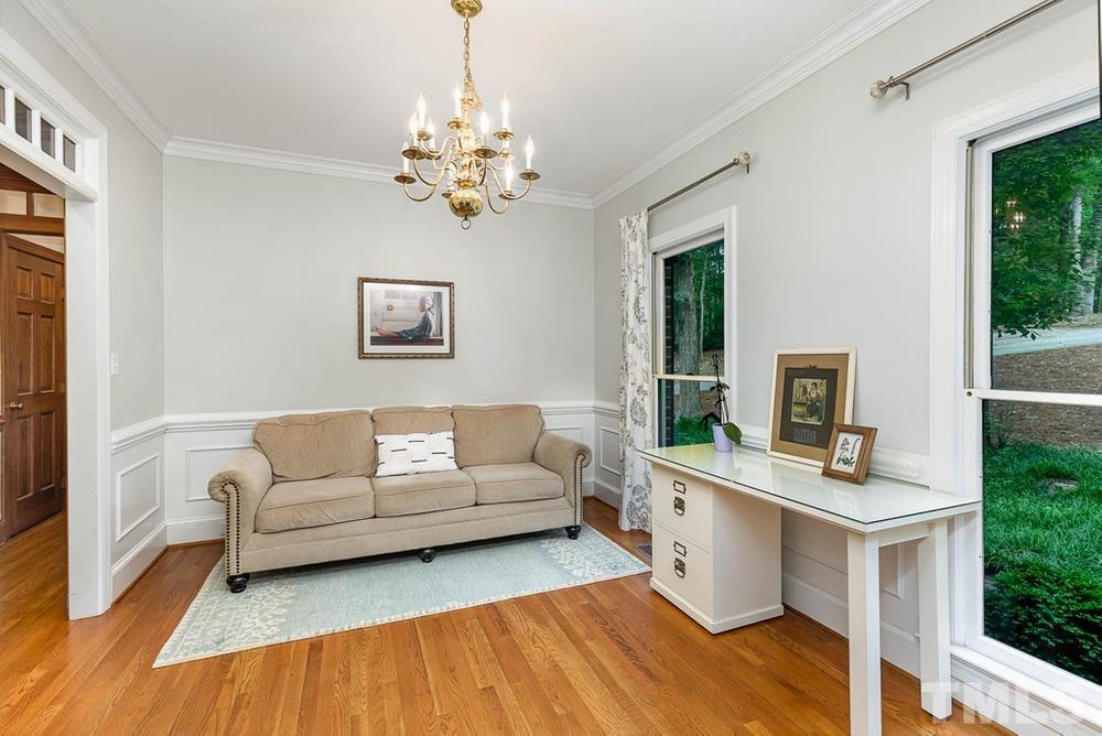 705 Presnell Court Raleigh, NC 27615 - Photo 8 of 30 a living room with furniture and a fireplace