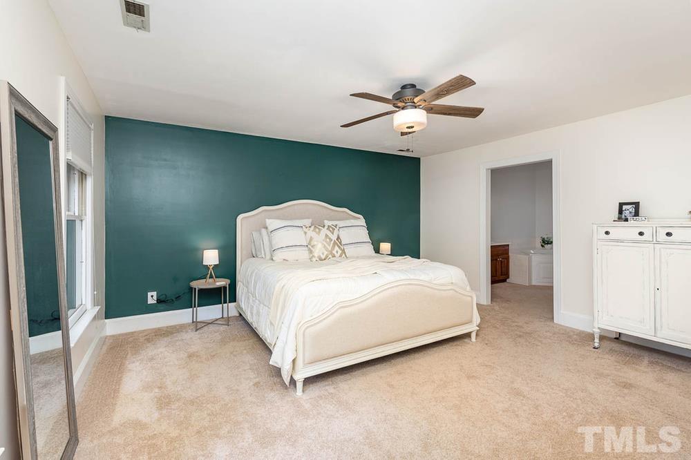 705 Presnell Court Raleigh, NC 27615 - Photo 10 of 30 a bedroom with a bed and a ceiling fan
