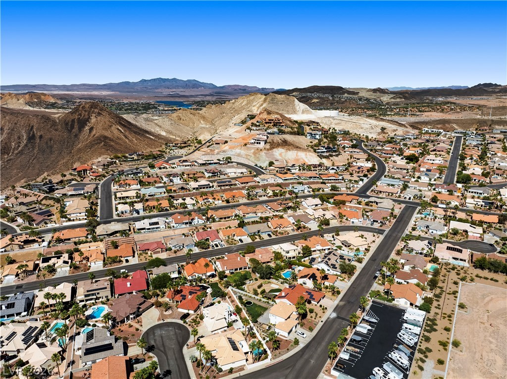 1135 Calico Ridge Drive Henderson, NV 89011 - Photo 67 of 86 An aerial perspective showcases a vibrant desert community nestled among rolling hills with mountain views.