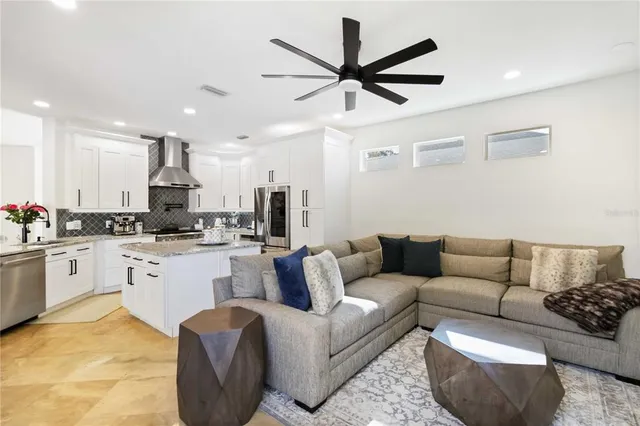 a living room with furniture and kitchen view