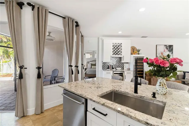 a kitchen with a sink stove cabinets and refrigerator