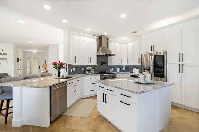 a kitchen with a sink stove cabinets and refrigerator