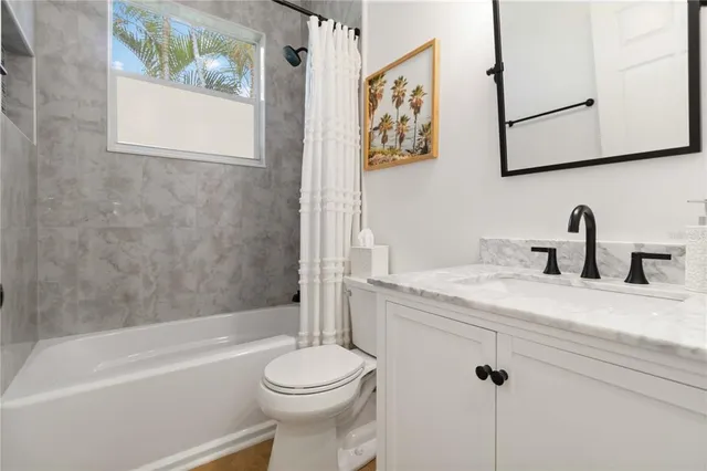 a bathroom with a toilet a sink and bathtub