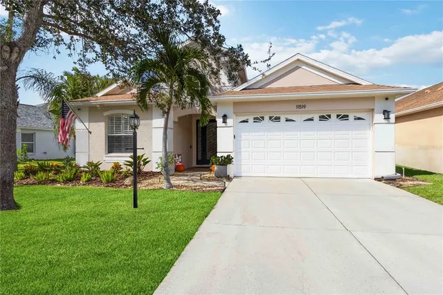 a front view of a house with a garden and yard