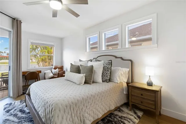 a bedroom with bed and wooden floor