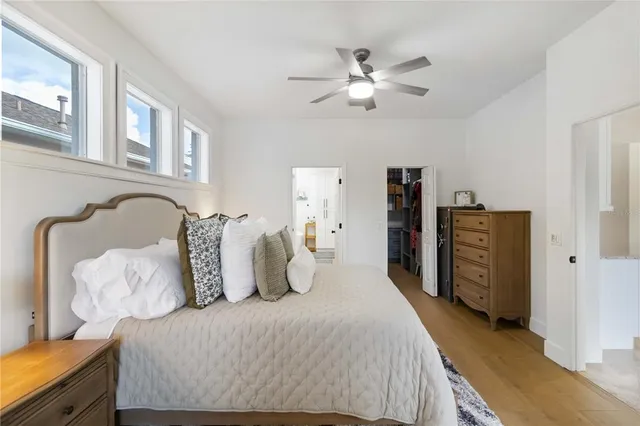 a bedroom with bed and wooden floor