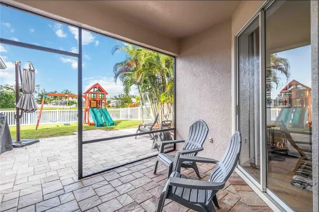 a dining room with furniture and a floor to ceiling window