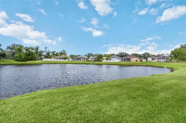 a view of a lake with houses in the back