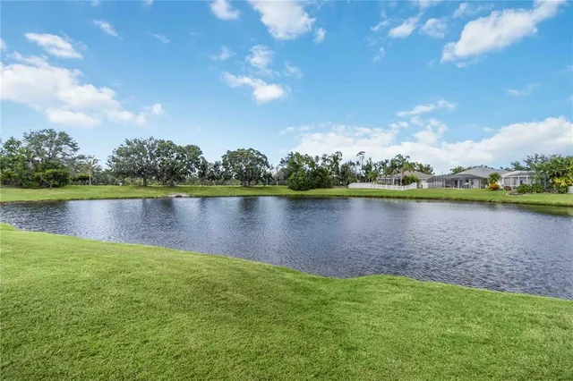 a front view of a house with a yard and swimming pool