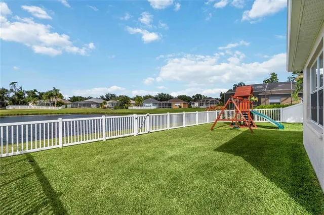 an aerial view of a house with a lake view