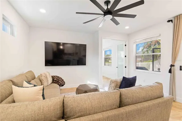 a living room with furniture and kitchen view
