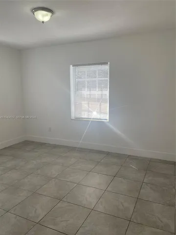 an empty room with a empty space and window