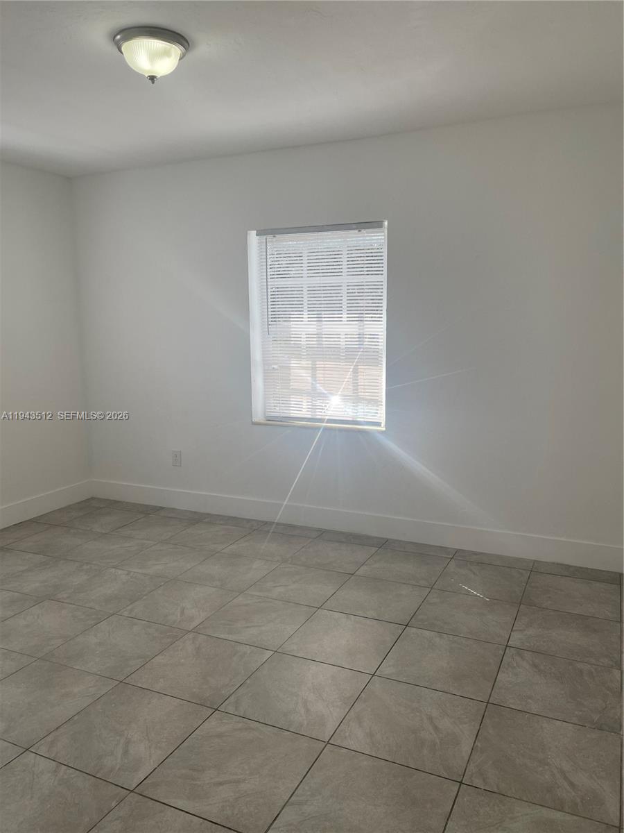 317 East 8th Street, Unit 1 Hialeah, FL 33010 - Photo 13 of 21 an empty room with a empty space and window