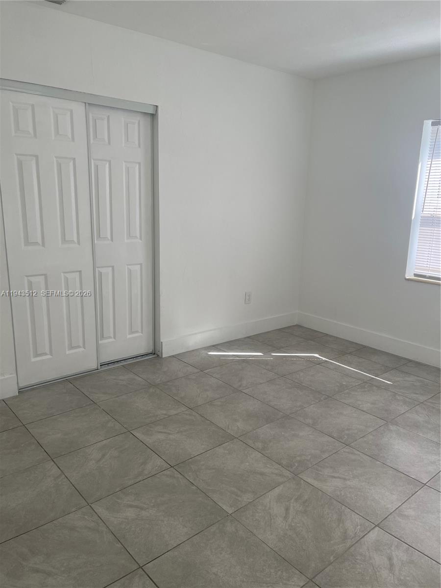 317 East 8th Street, Unit 1 Hialeah, FL 33010 - Photo 14 of 21 an empty room with windows