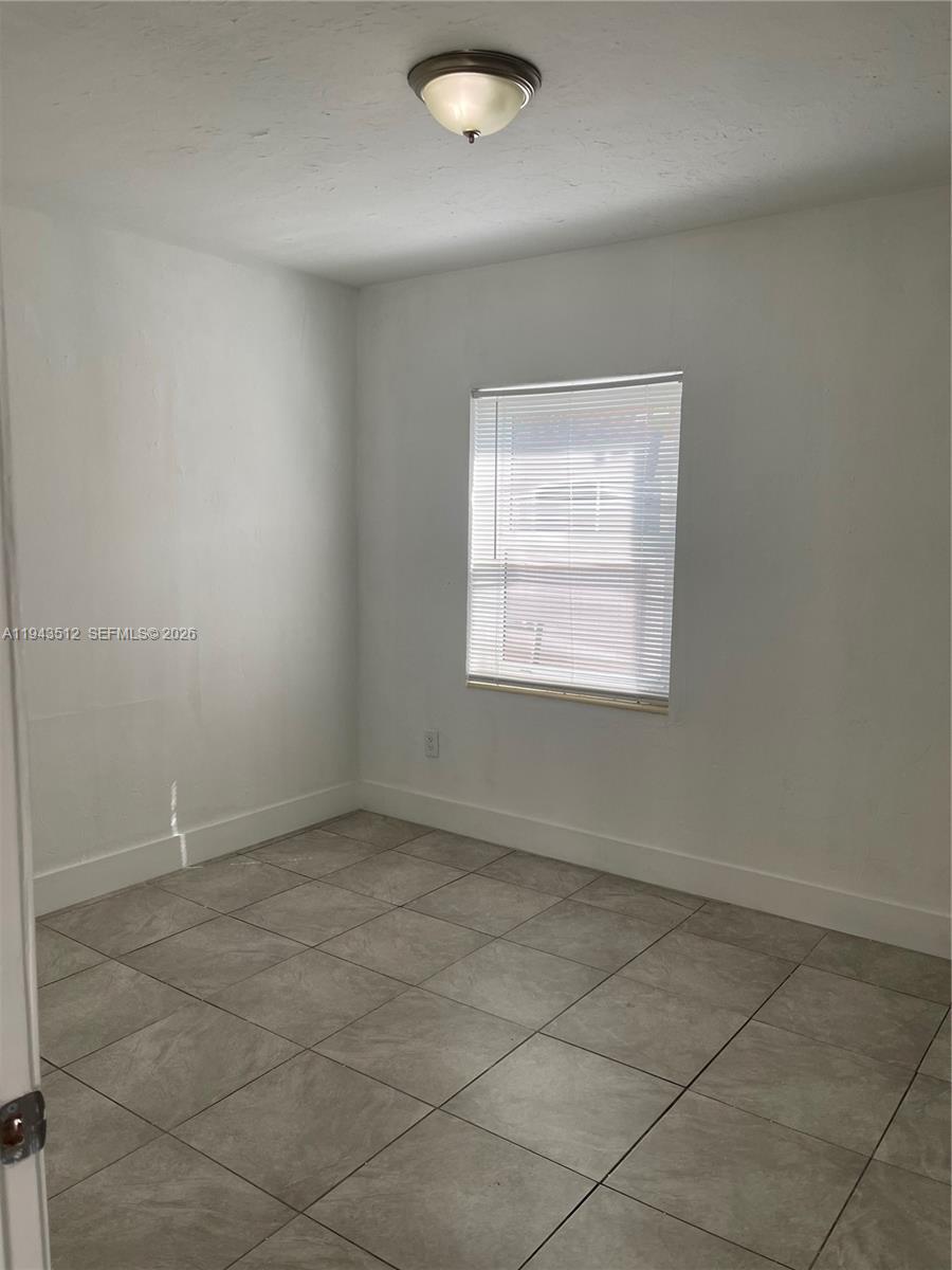 317 East 8th Street, Unit 1 Hialeah, FL 33010 - Photo 17 of 21 an empty room with a empty space and a window