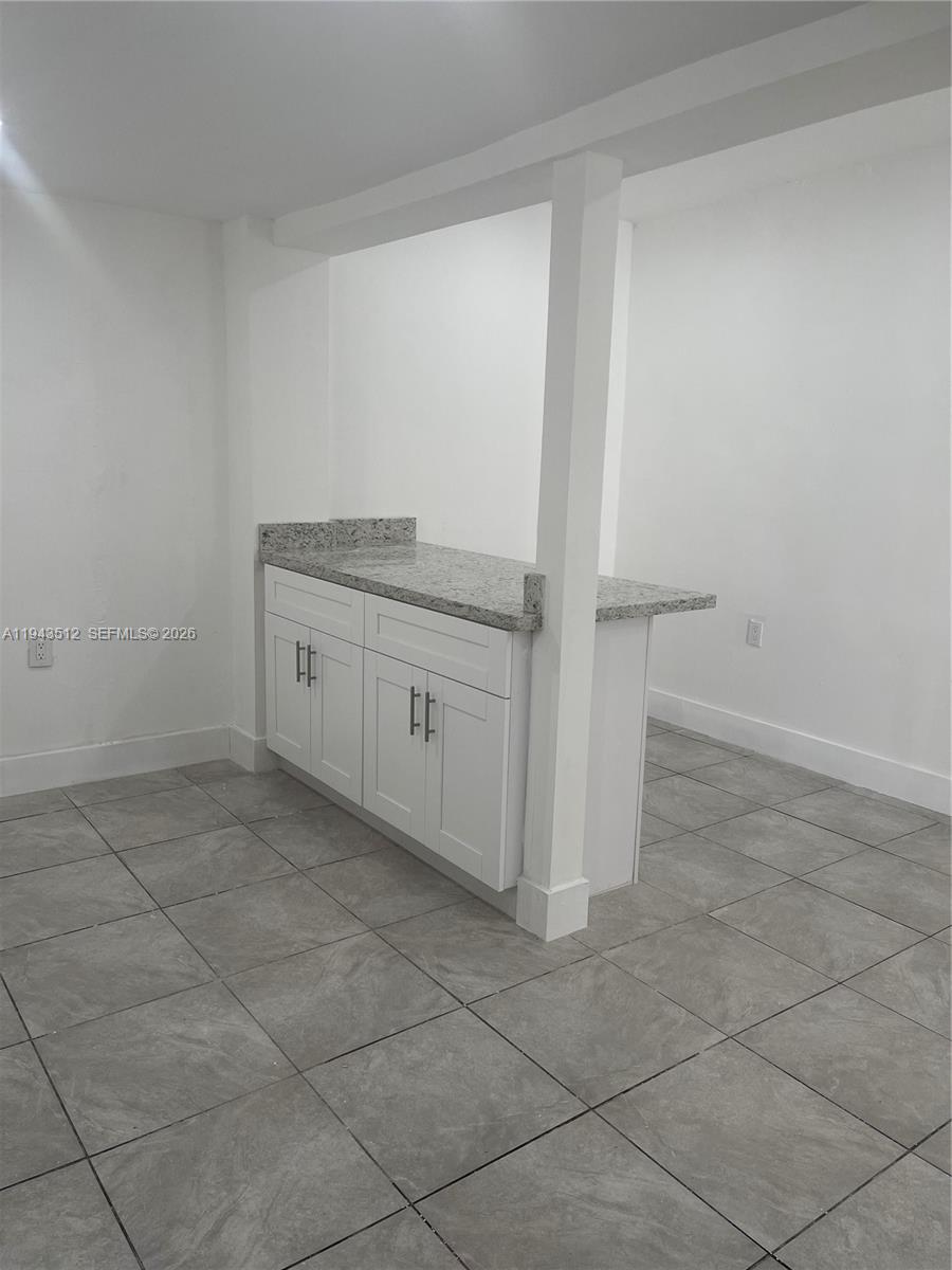317 East 8th Street, Unit 1 Hialeah, FL 33010 - Photo 6 of 21 a bathroom with a granite countertop sink and a mirror