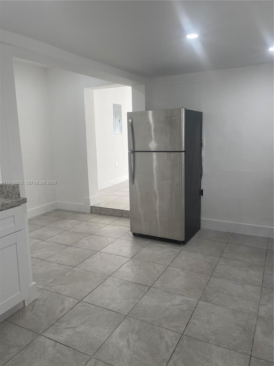 317 East 8th Street, Unit 1 Hialeah, FL 33010 - Photo 7 of 21 a view of a refrigerator in kitchen and an empty room