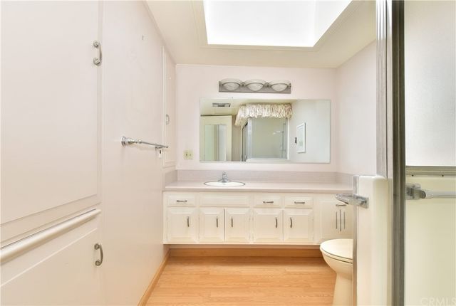 a bathroom with a sink a toilet and mirror