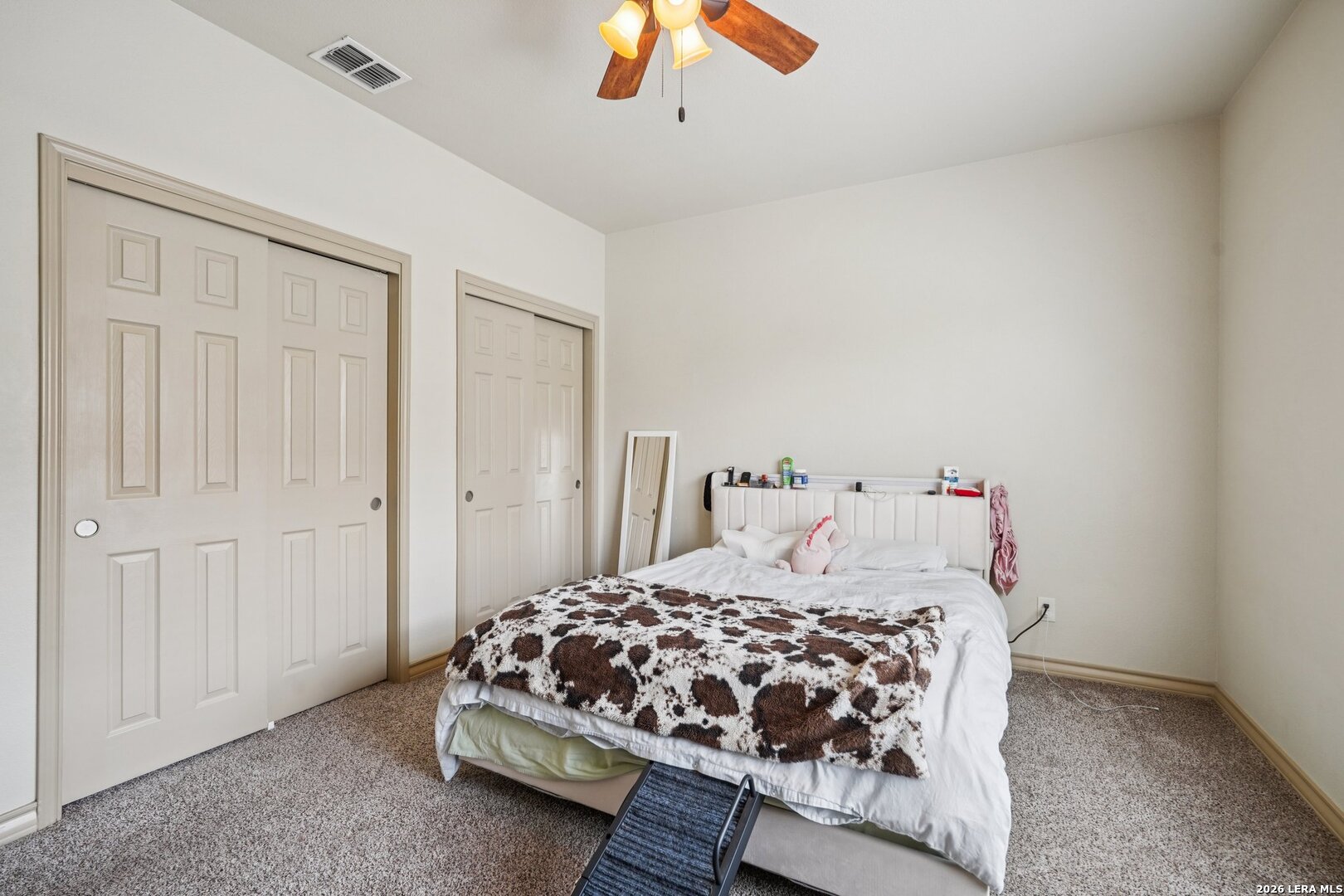2312 Sailing Way, Unit C Kerrville, TX 78028 - Photo 16 of 26 a bedroom with a bed and a chandelier fan