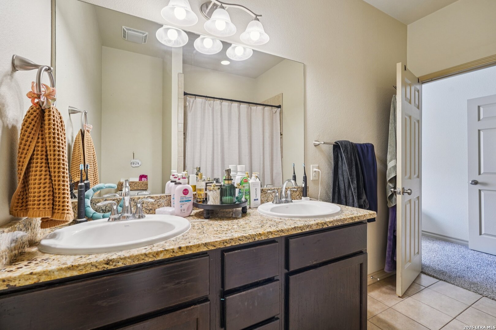2312 Sailing Way, Unit C Kerrville, TX 78028 - Photo 18 of 26 a bathroom with a granite countertop sink and a mirror