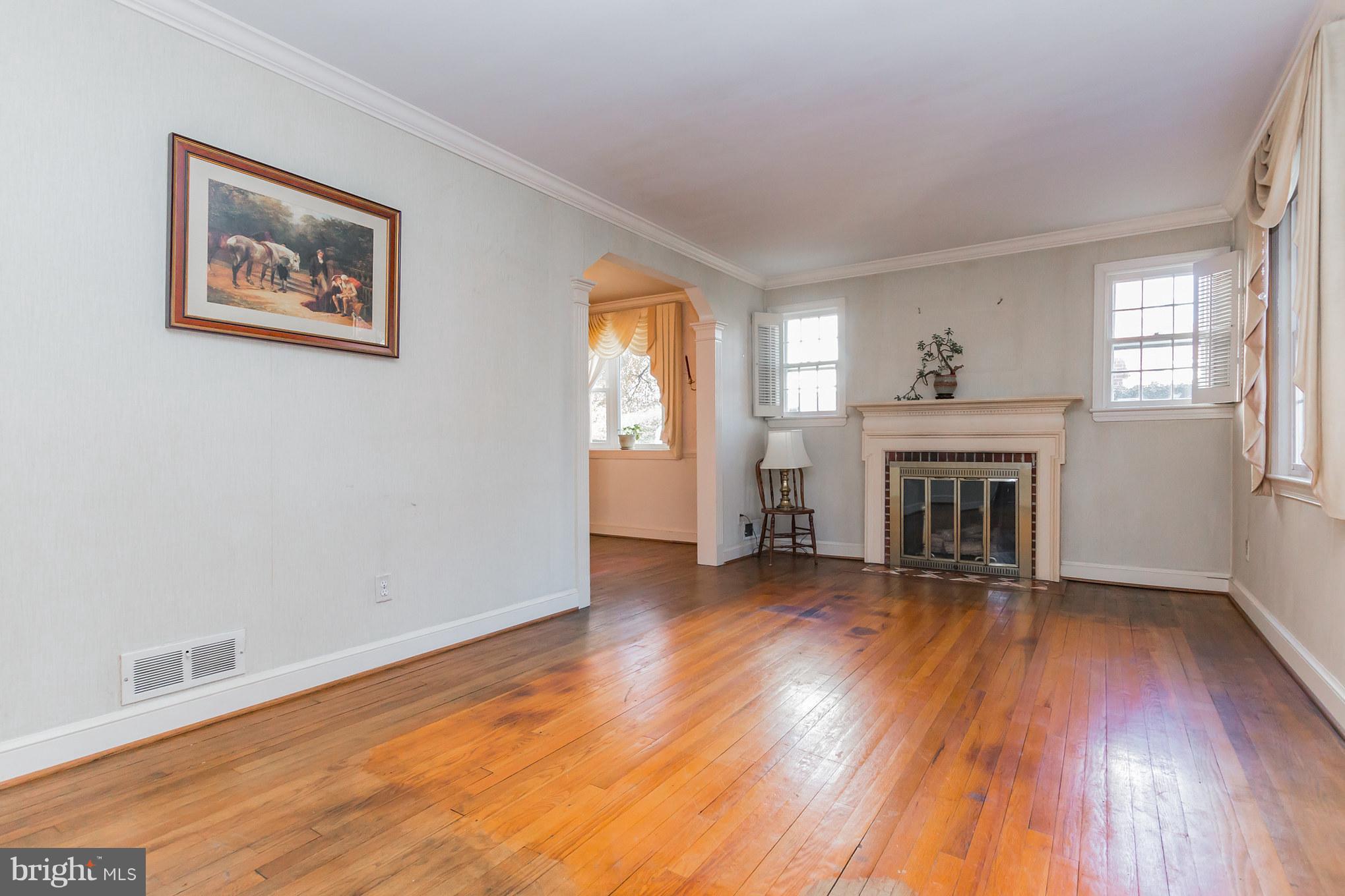 2009 Dayton Street Silver Spring, MD 20902 - Photo 3 of 30 a view of a livingroom with wooden floor and a fireplace