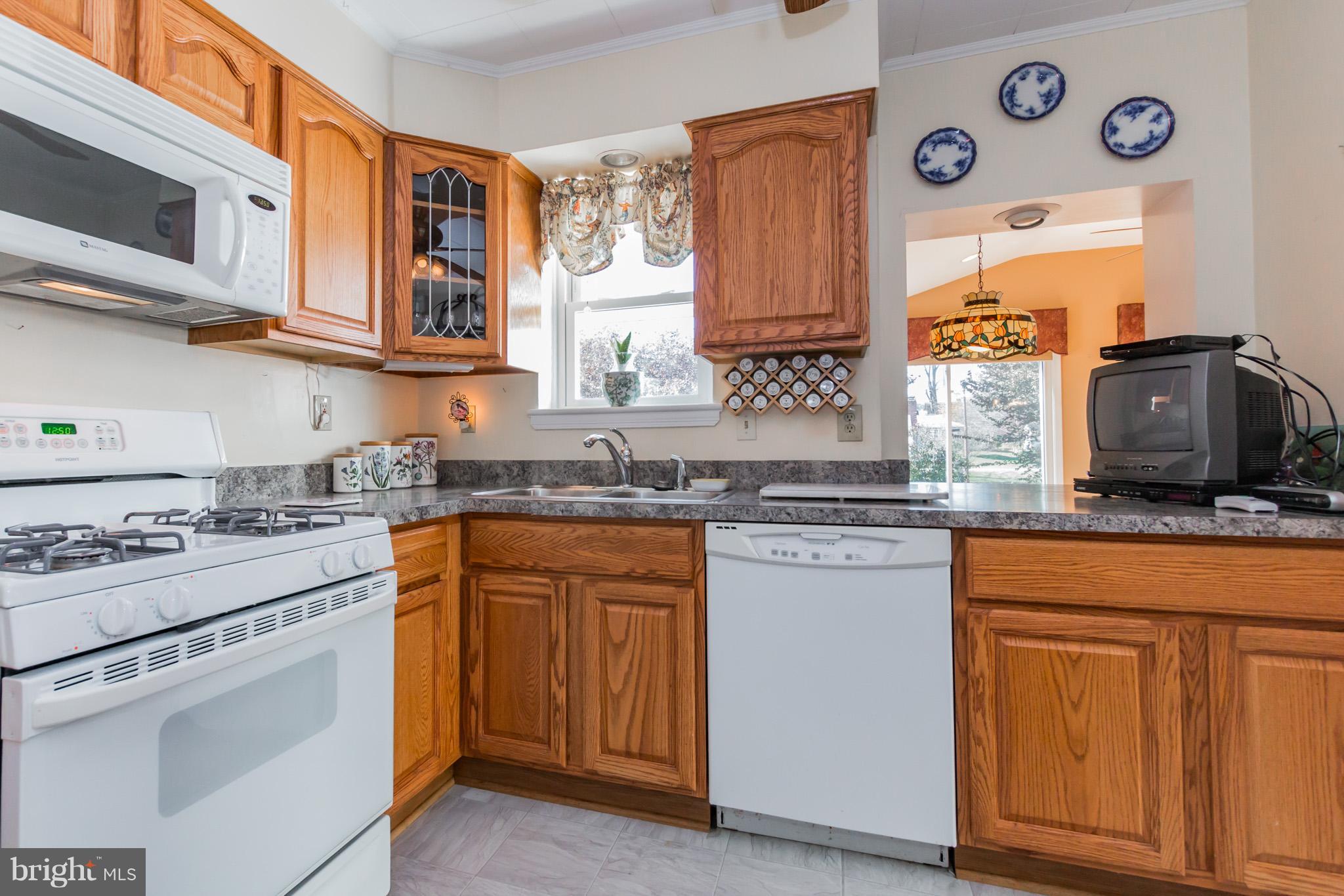 2009 Dayton Street Silver Spring, MD 20902 - Photo 7 of 30 a kitchen with stainless steel appliances granite countertop a stove and a sink