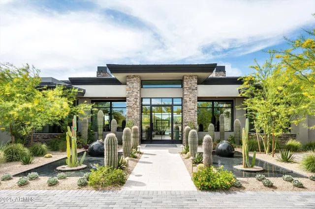 a living room with furniture a ceiling fan and a large window